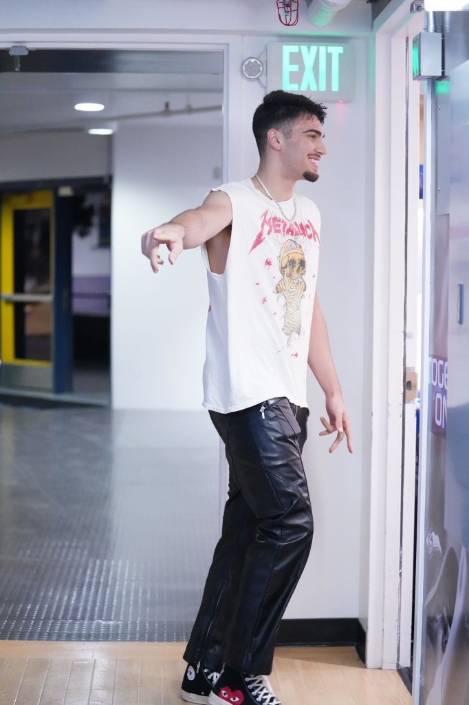 Ben Shtolzberg in a Metallica tee and leather pants at the arena tunnel exit